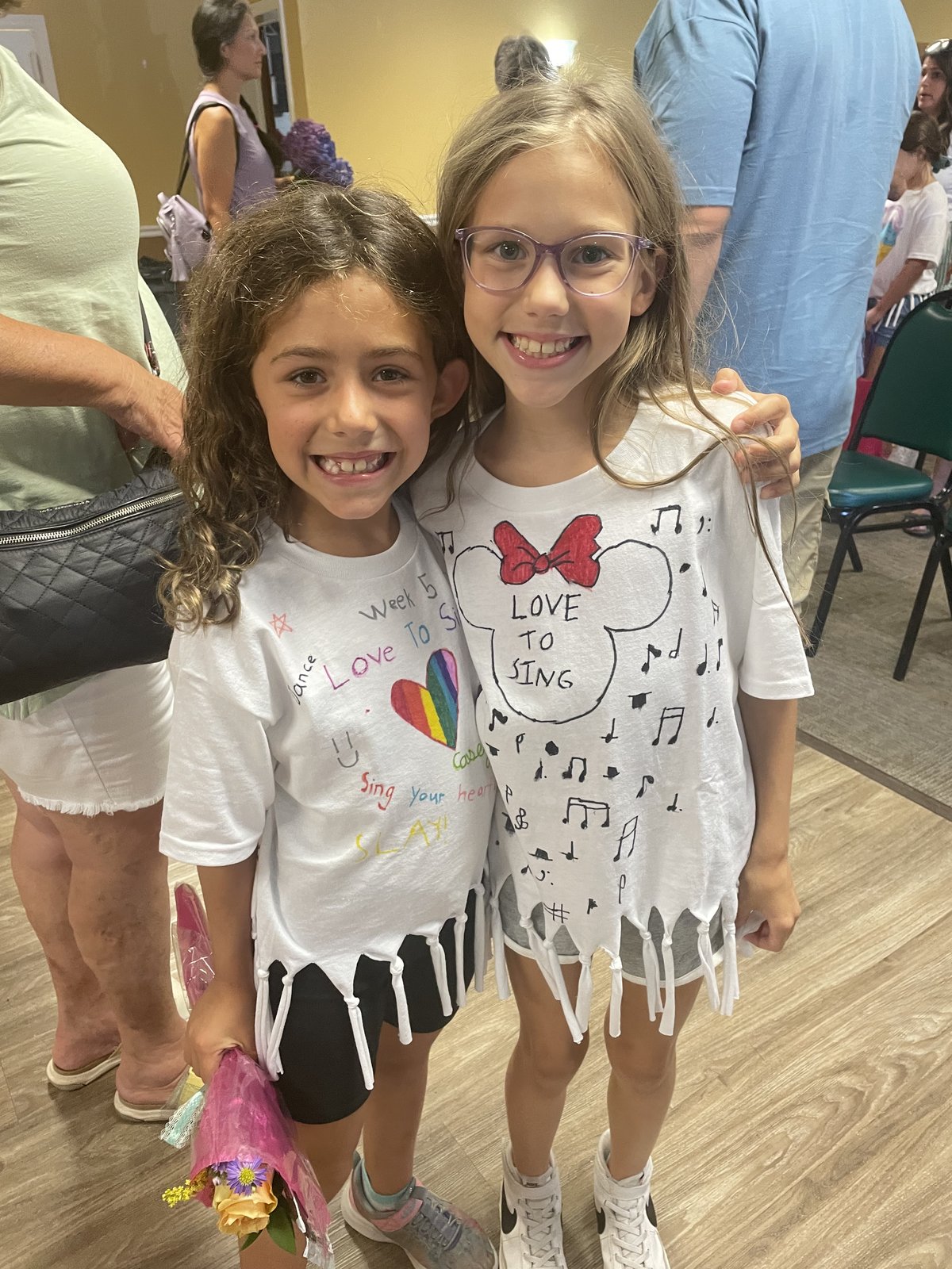 Campers showing decorated Love To Sing t-shirts